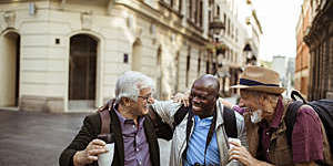 Close up of a group of male senior tourists exploring the city