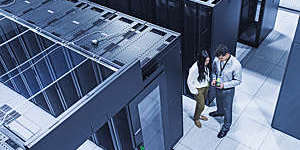 High angle view of technicians talking in server room