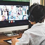 Woman working at home having a video conference with colleagues