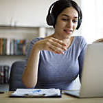 Young woman having video call on laptop computer at home