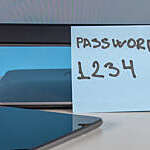 Weak password on flying note with a keyboard in foreground. 