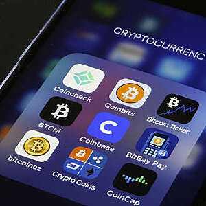 PARIS, FRANCE - FEBRUARY 26: In this photo illustration, the Coinbase cryptocurrency exchange logo (C) is seen on the screen of an iPhone on February 26, 2021 in Paris, France. Cryptocurrency trading platform Coinbase has filed for registration with the SEC on Thursday for an IPO via direct listing on the Nasdaq and will likely be the largest IPO of the year. Coinbase reported $ 1.28 billion in revenue in 2020 (+ 140% year on year), for net profit of $ 320 million. (Photo illustration by Chesnot/Getty Images)
