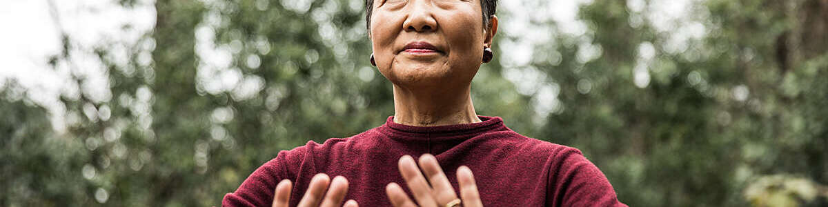 Senior woman doing Tai Chi outdoors