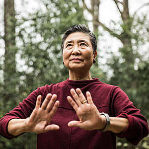 Senior woman doing Tai Chi outdoors